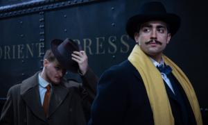 Two men in front of a train.