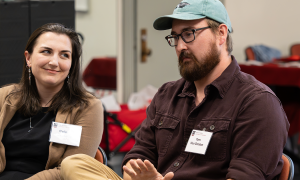 A woman and man speaking on a panel
