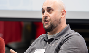 man speaking on a panel