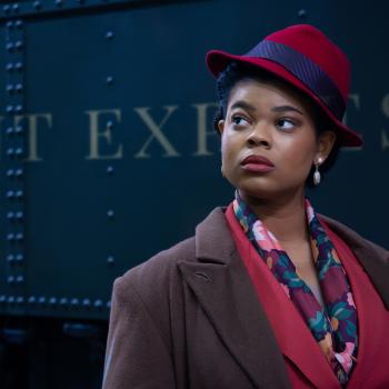 A woman in front of a train