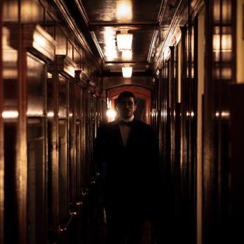 A man in a train corridor